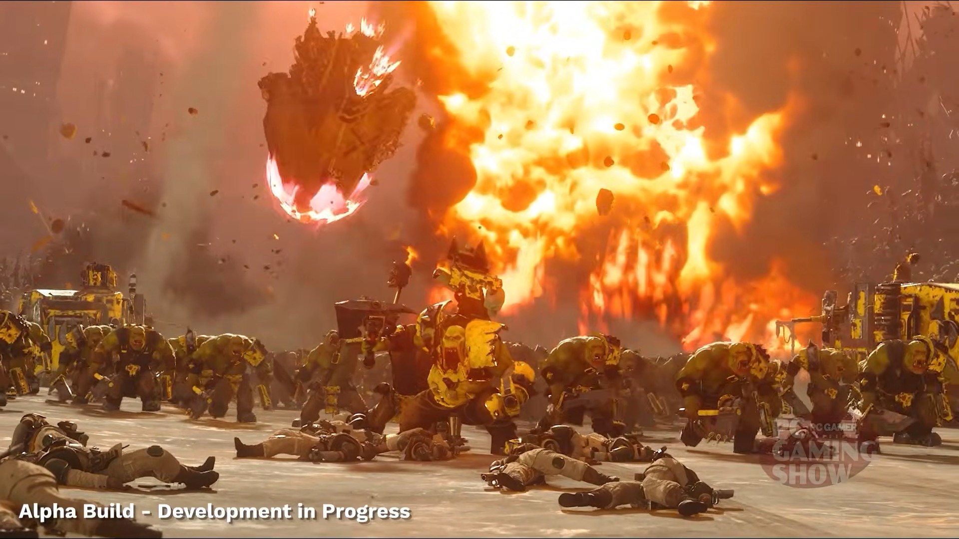 Chaotic battle scene with fierce, armored orc-like creatures and scattered bodies amidst blazing explosion. Intense, fiery atmosphere. Text: "Alpha Build - Development in Progress."