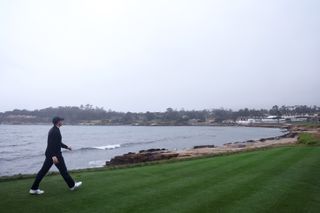 Rory McIlroy walks down the 18th hole at Pebble Beach