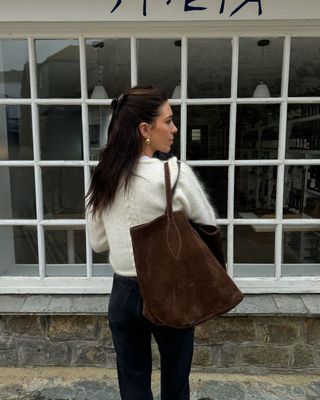 Jessica with a brown suede bag and cream jumper