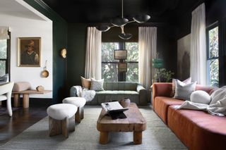 Dark green living room with orange couch