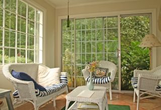 interior view from sunroom with white wicker furniture