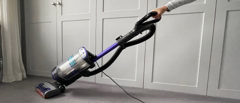 The Shark Anti Hair Wrap Upright Vacuum Cleaner with Powered Lift-Away NZ850UK being used to clean carpet