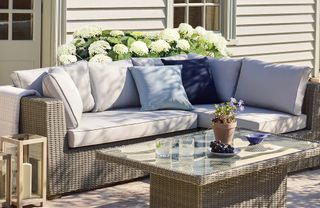 A rattan garden sofa and table set