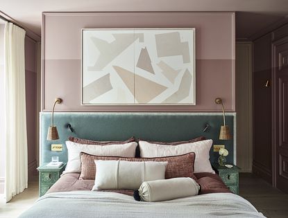 a bedroom with sage green bedhead and dusky pink walls