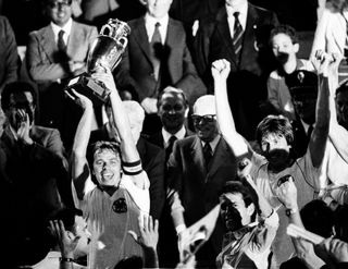 West Germany captain Bernard Dietz lifts the European Championship trophy after victory over Belgium in the final of Euro 1980.