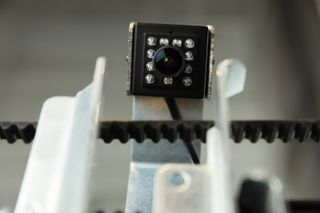 View of a square black camera along with metal and black components