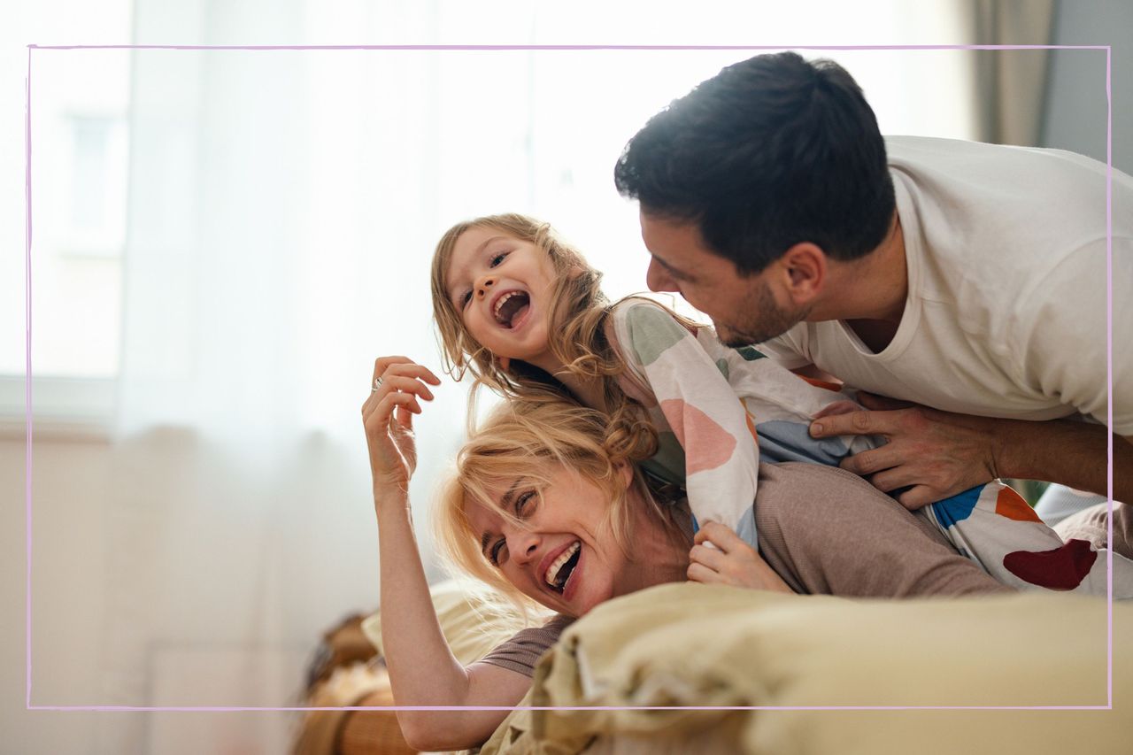 Smiling parents with their daughter