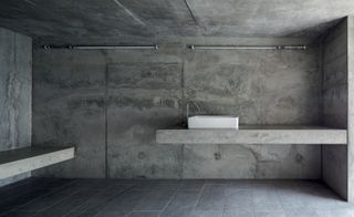 Macuga’s cast-concrete bathroom, which includes a heated concrete bench