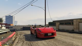 A red car on a Los Santos hilltop in GTA 5 Enhanced