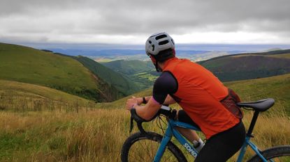 Image shows gravel cyclist looking at view