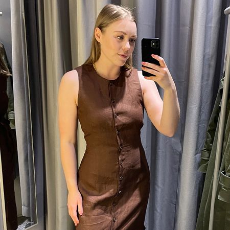 Woman in dressing room wears brown linen vest dress