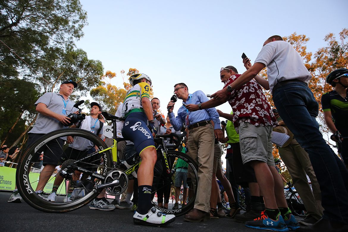 Caleb Ewan surrounded by press at the finish