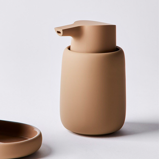A terracotta ceramic smooth soap dispenser