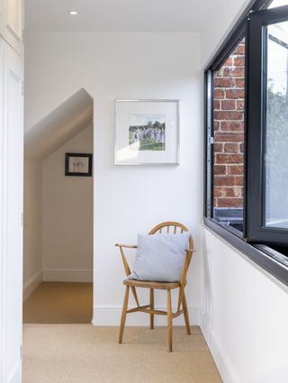 white landing with chair and bifold windows