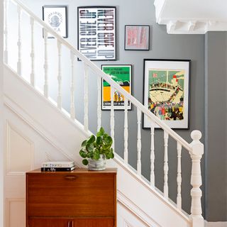 grey hallway with artwork up stairs