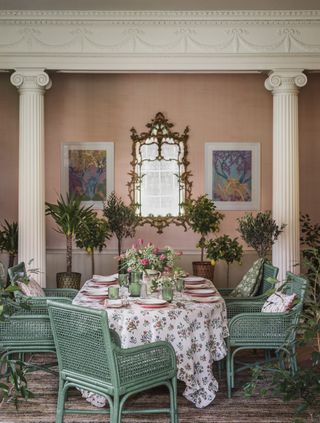 green wicker chairs in classical designed pink dining room