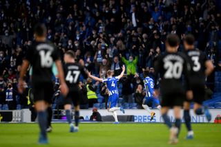 Brighton defender Adam Webster, number four, soaks up the acclaim of the euphoric Amex Stadium crowd as Manchester City's despondent players watch on. On the night fans were permitted to return to Premier League games, Albion made it an unforgettable occasion for the 7,945 in attendance. Webster's towering headed equaliser helped the hosts overturn a two-goal deficit en route to claiming a thrilling 3-2 win