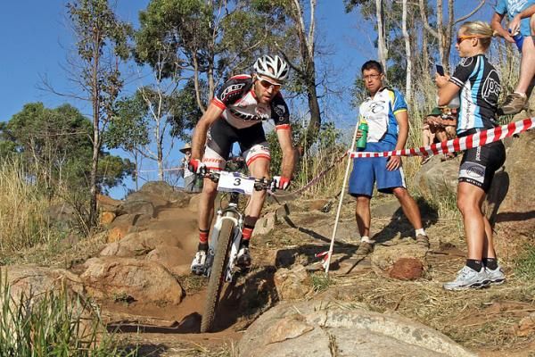Andy Blair, winner of the elite men's overall races the super D as Jodie Willett looks on, watching his lines.
