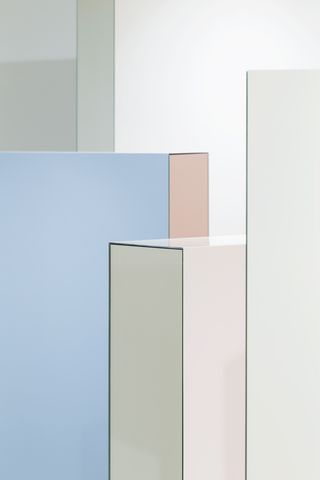 Close up view of light blue, pink and mirrored walls