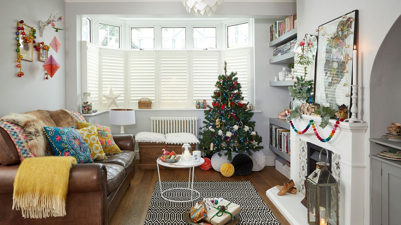 A living room filled with bohemian styled Christmas decorations as well as a tree and fireplace to support why Boxing Day is the best time to sell a home