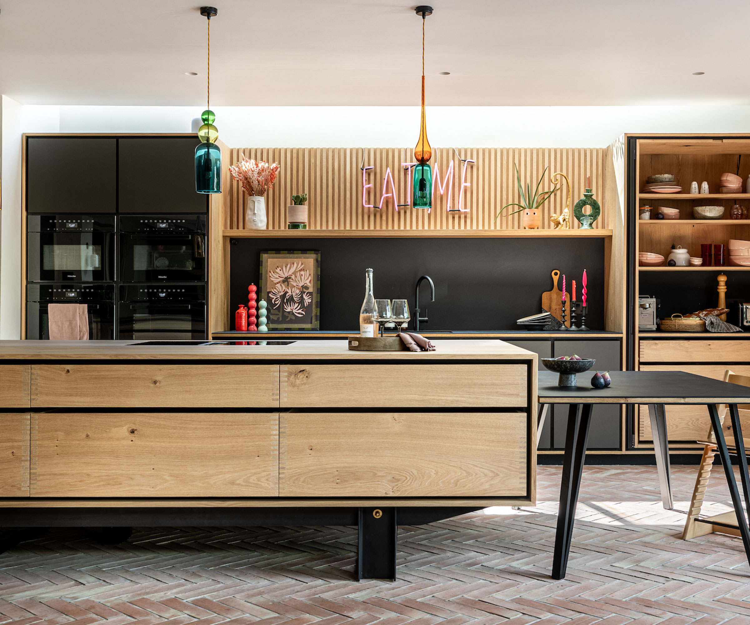 modern wooden kitchen with brick flooring and long rooflight
