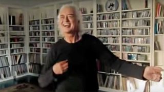 Jimmy Page playing air guitar at home