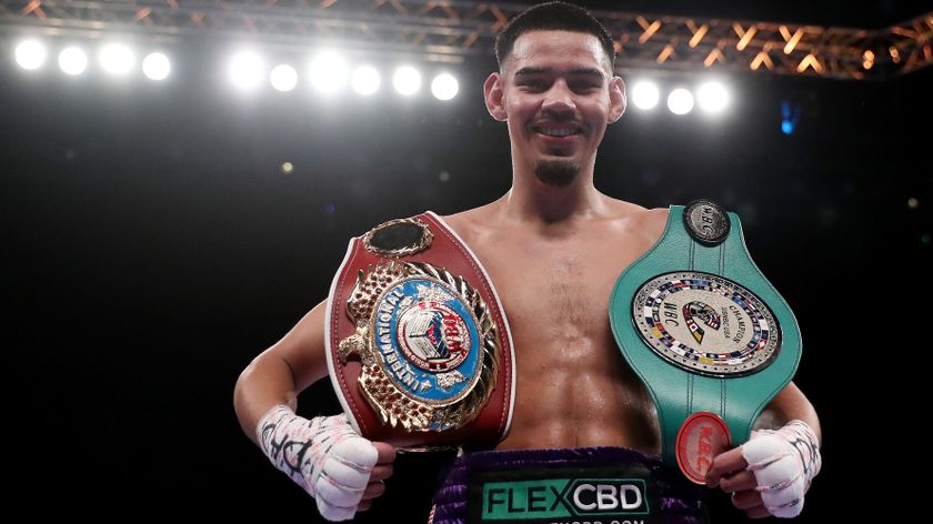 Diego Pacheco poses for a photograph with his Title Belts as they celebrate after defeating Jack Cullen during the WBO International Super Middle Title fight