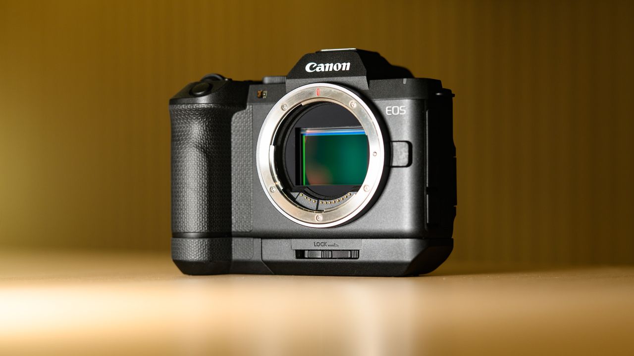 Canon EOS R8 Mark II on a wooden table, with grip attached