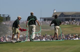 Greenkeepers water the greens at Shinnecock Hills during the 2004 US Open