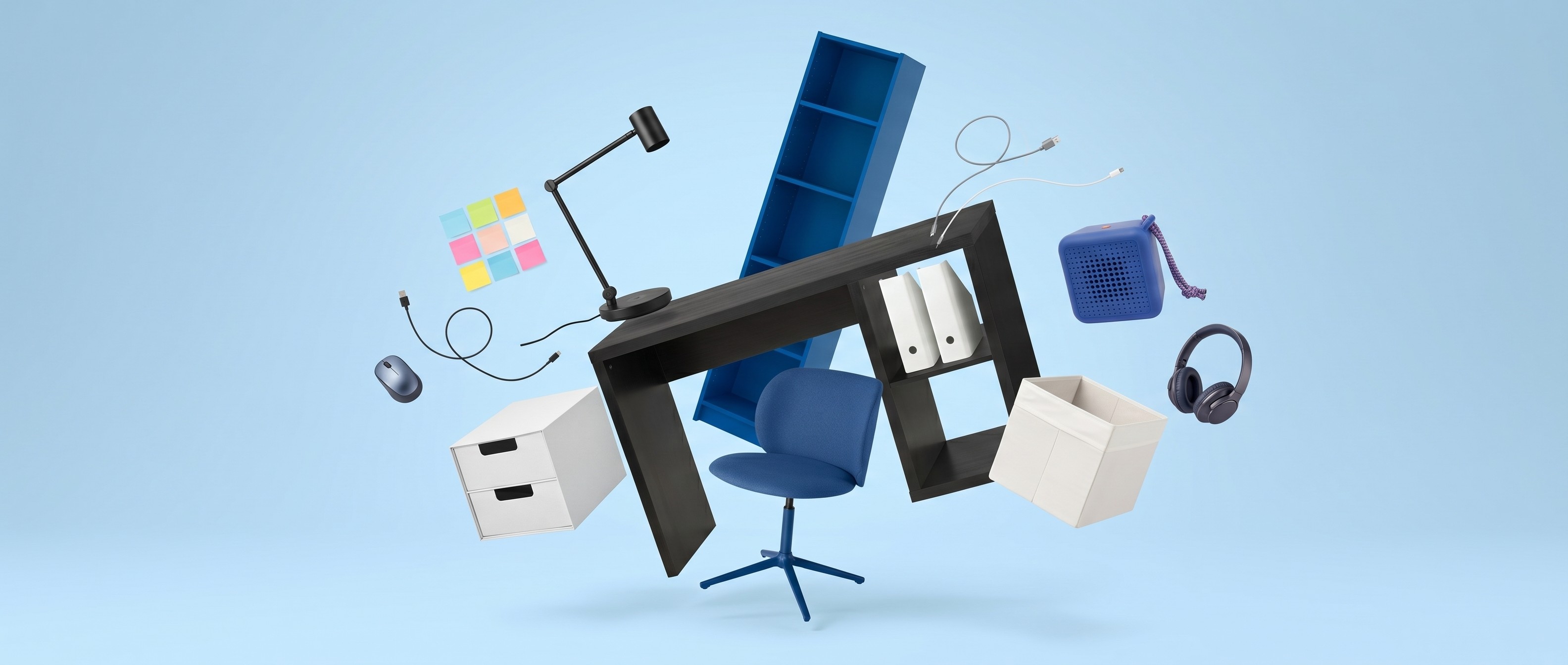 Collection of blue, white, and black office furniture and accessories, including blue IKEA Billy bookcase