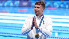 France's Léon Marchand soaks up the applause after winning gold in the men's 200m breaststroke