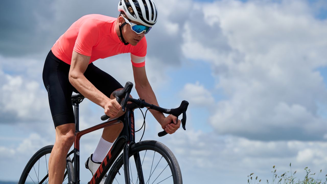 Male cyclist riding out the saddle