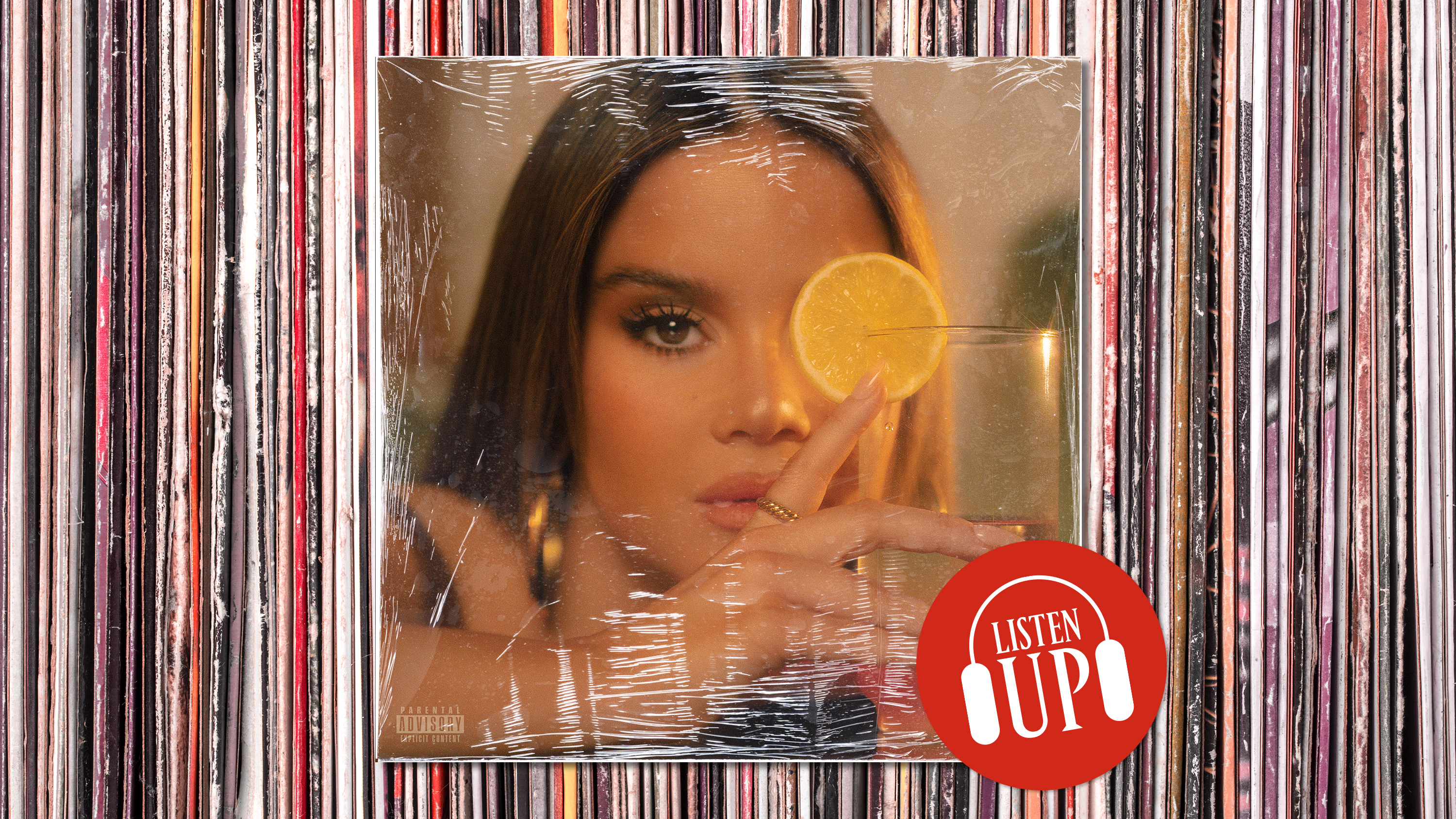 an image of maren morris' dreamsicle album art with her holding a glass of lemonade plastered over a stack of vinyl