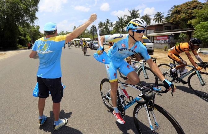 Ruslan Tleubayev (Astana) grabs his musette.