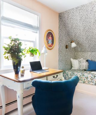 bedroom with light pink wall with wallpapered nook