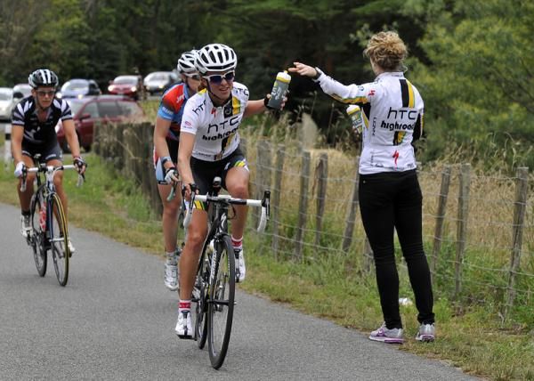 A rider from HTC Highroad grabs a bottle at the feed zone.