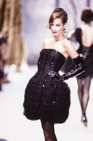 Christy Turlington wears a black dress on the Chanel runway in 1991