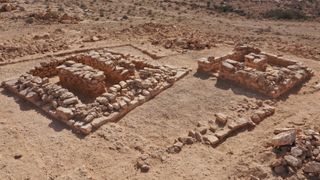 Two square tombs in the desert build with rock bricks