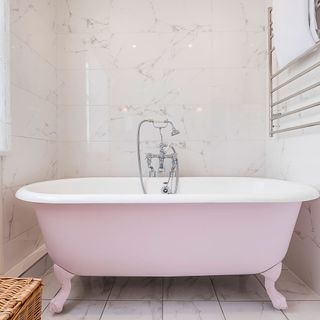 bathroom with tiles on wall and pink bathtub
