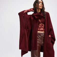 model wears lace top, deep red leather barrel pants, and deep red kimono with attached scarf