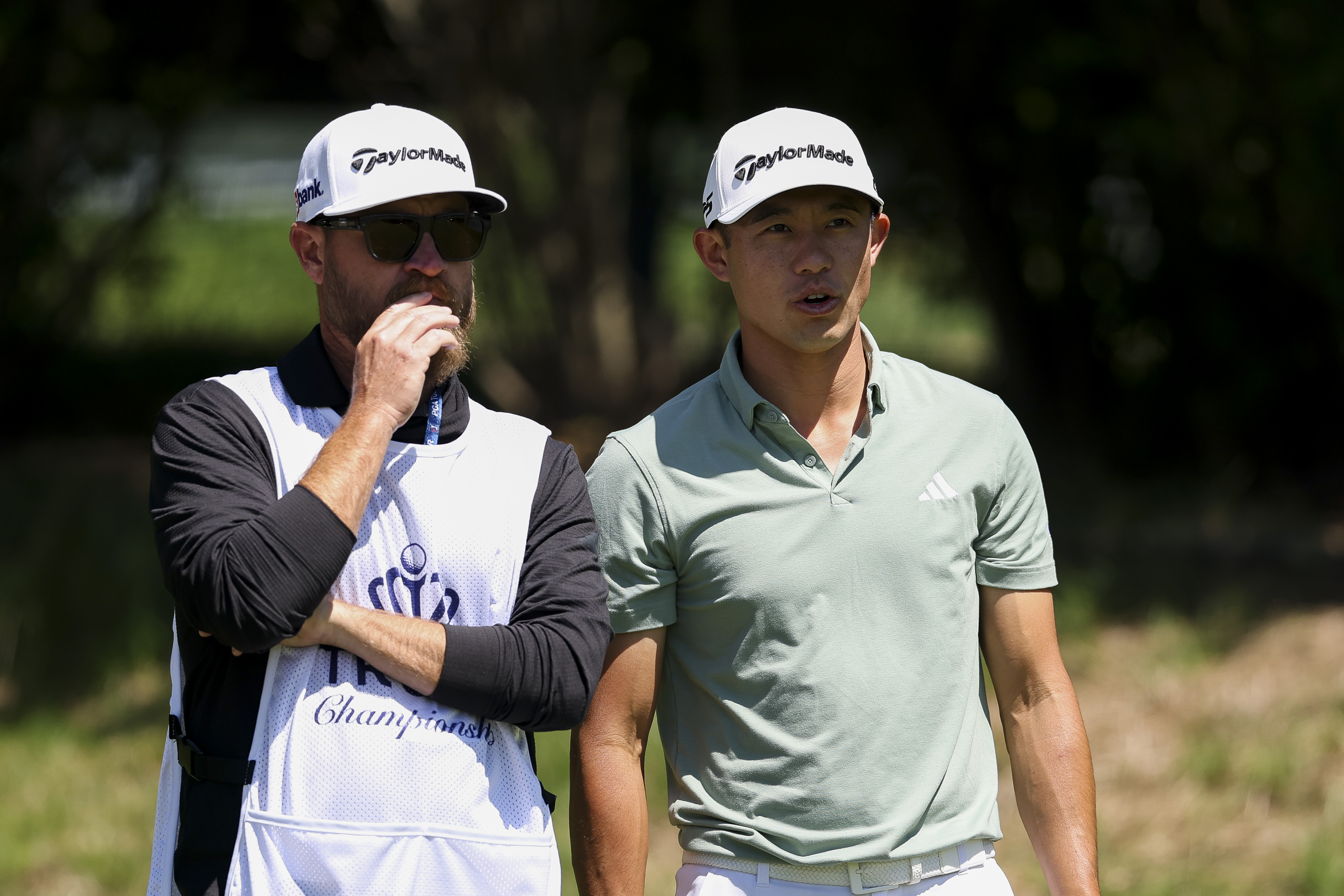 Collin Morikawa talks to his caddie during the Truist Championship