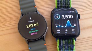 Close up of a Samsung Galaxy Watch 7 and Apple Watch SE 2022 next to each other on a wood table with results from a walk test shown on each