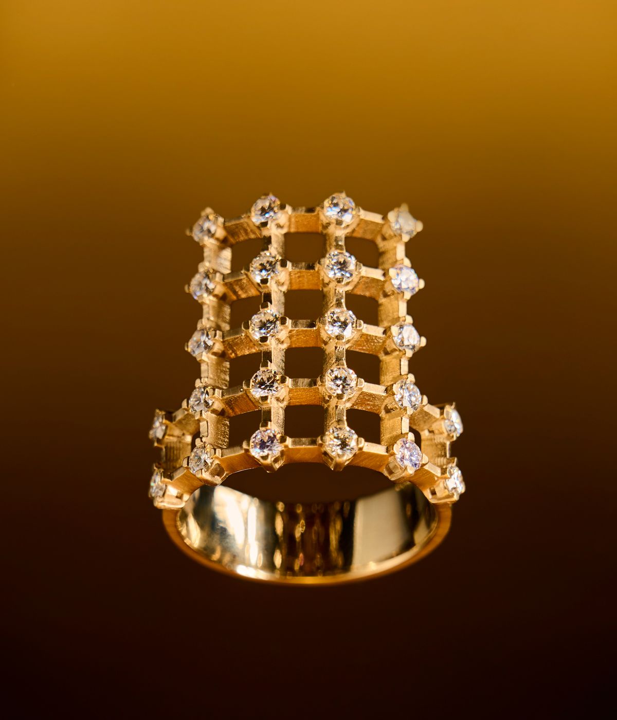 Dina Kamal gold ring on gold background