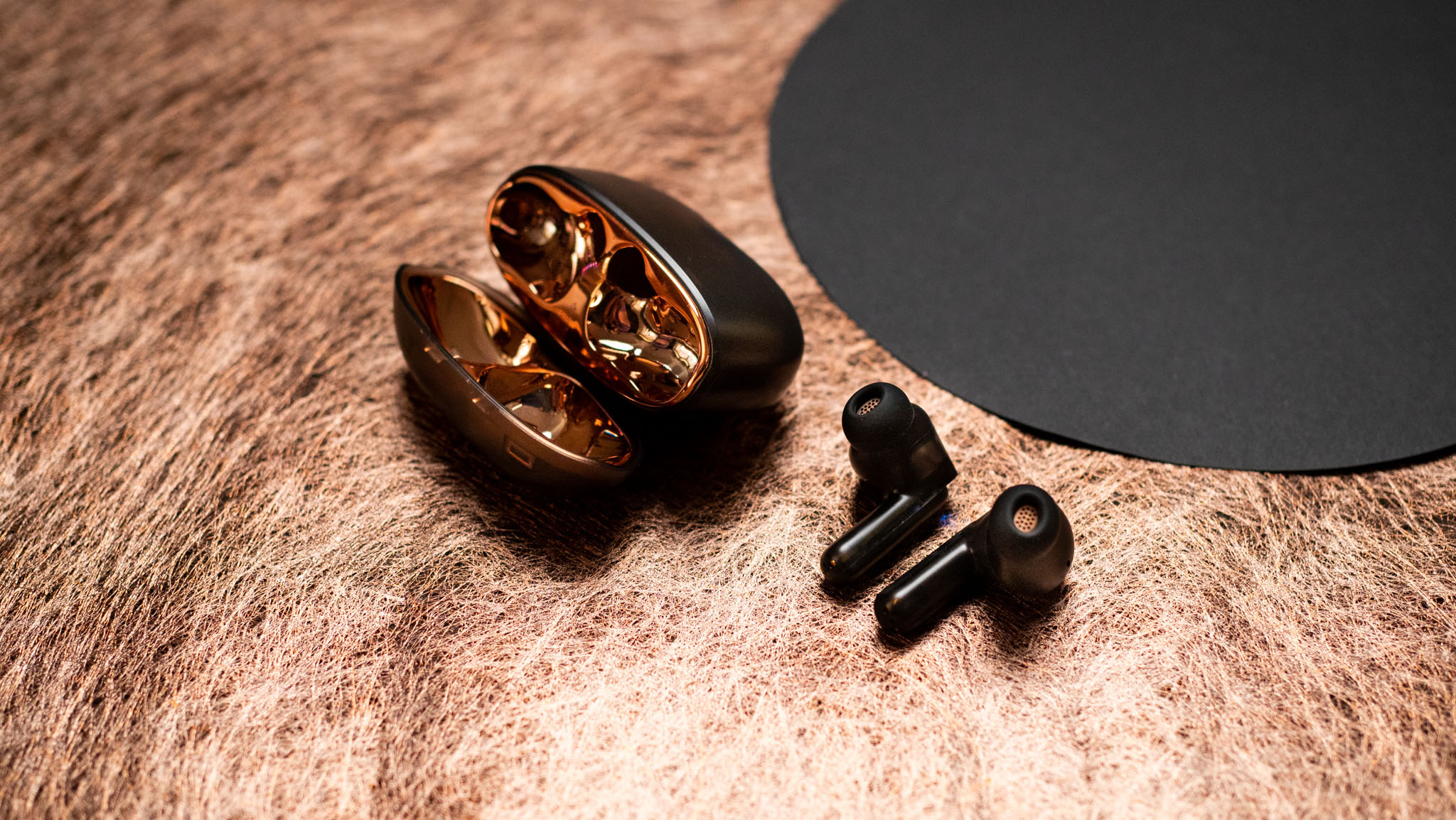 Creative Aurvana Ace 2 earbuds next to case