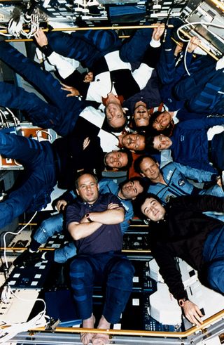 Inside the Spacelab Science Module, the crews of STS-71, Mir-18 and Mir-19 pose for the traditional inflight picture. STS-71 was the first U.S. Space Shuttle- Russian Space Station Mir docking and joint on-orbit operation.