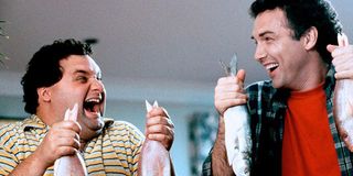 Norm and Artie laughing while holding fish in Dirty Work.