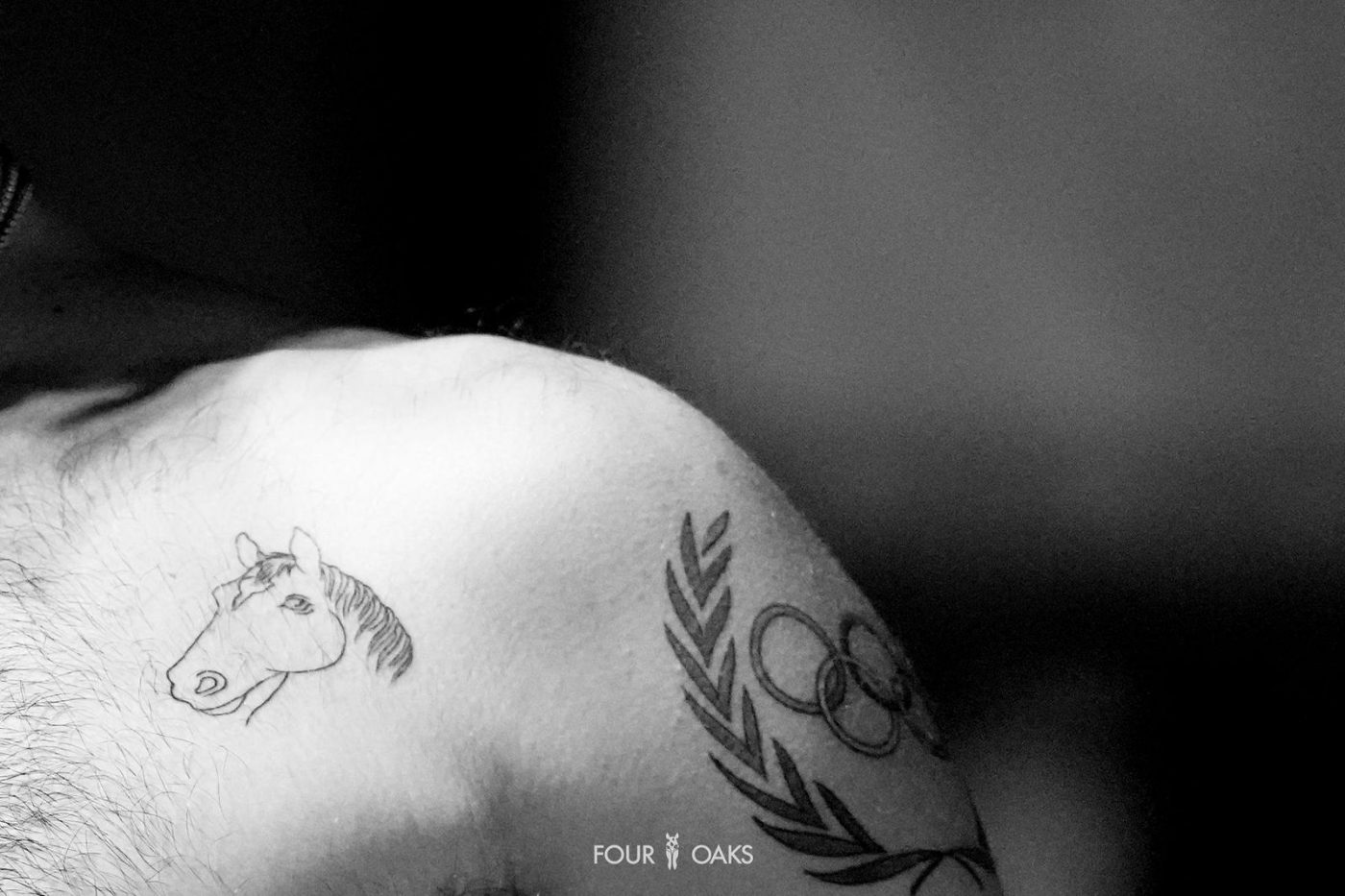 Former Olympic showjumper Teddy Vlock shows off his Olympic rings and horse tattoo