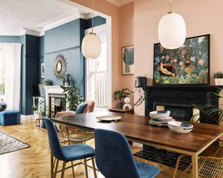 An open plan living area with dining table and fireplace