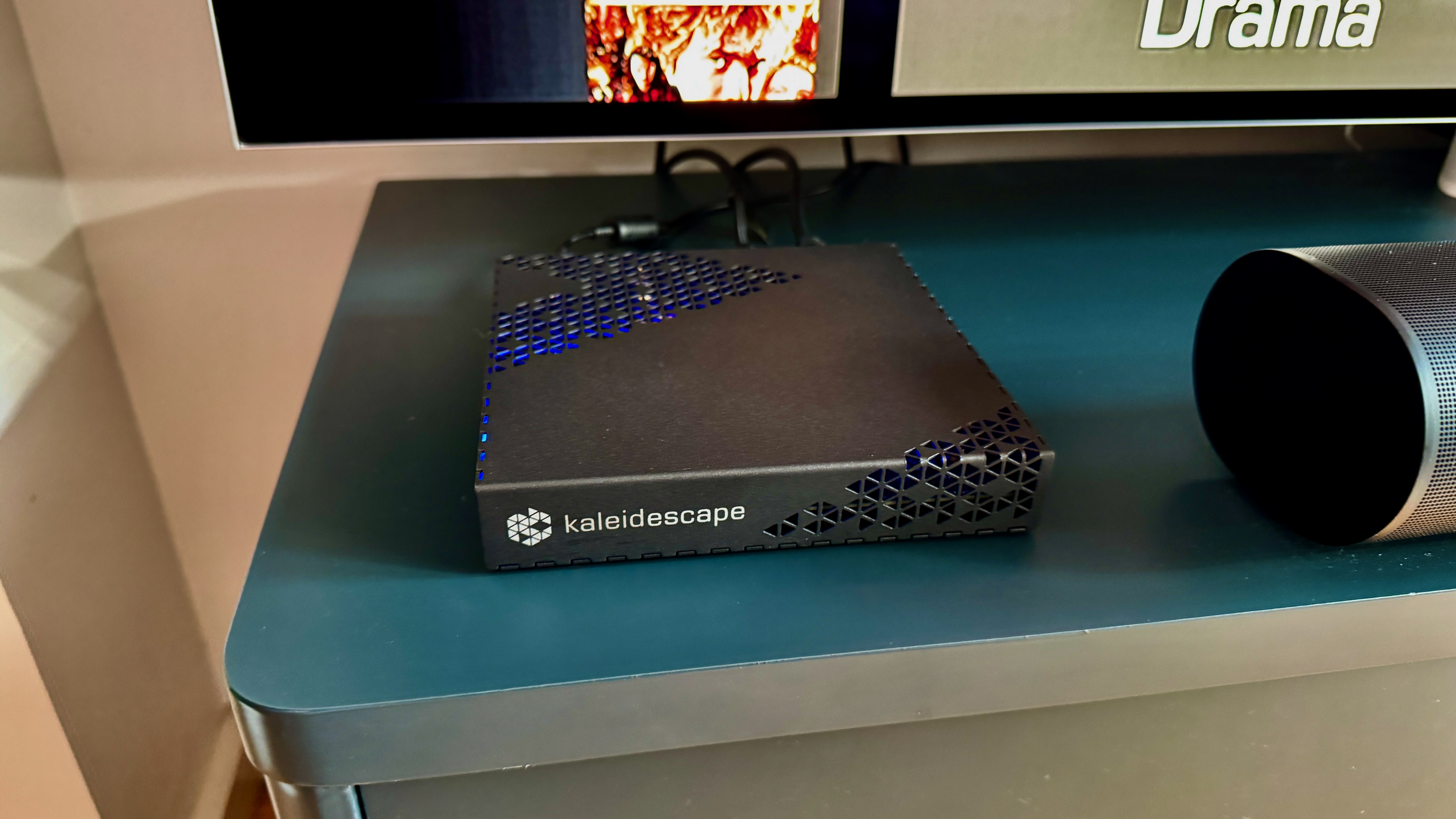Kaleidescape Strato E Movie Player on a blue TV unit.