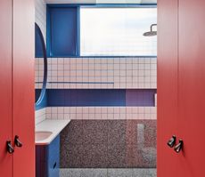 A bathroom with colored grout